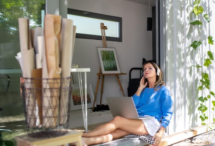 studio Mature woman working in home studio in backyard.